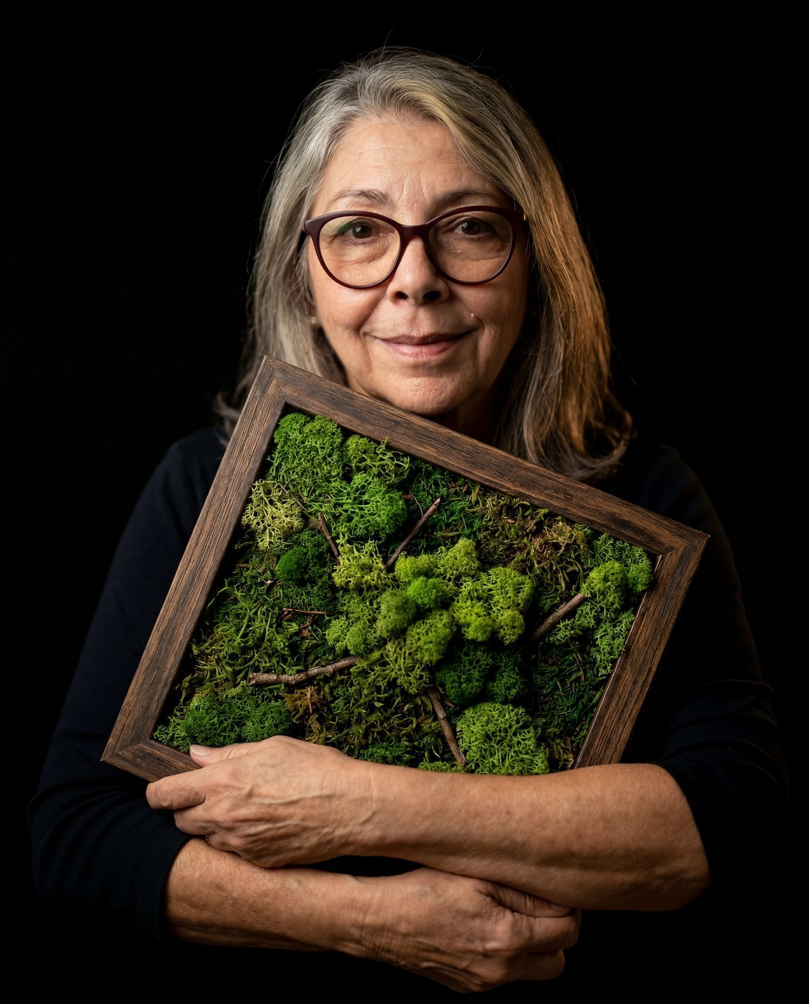 Maru holding one of her biophilic moss art creations