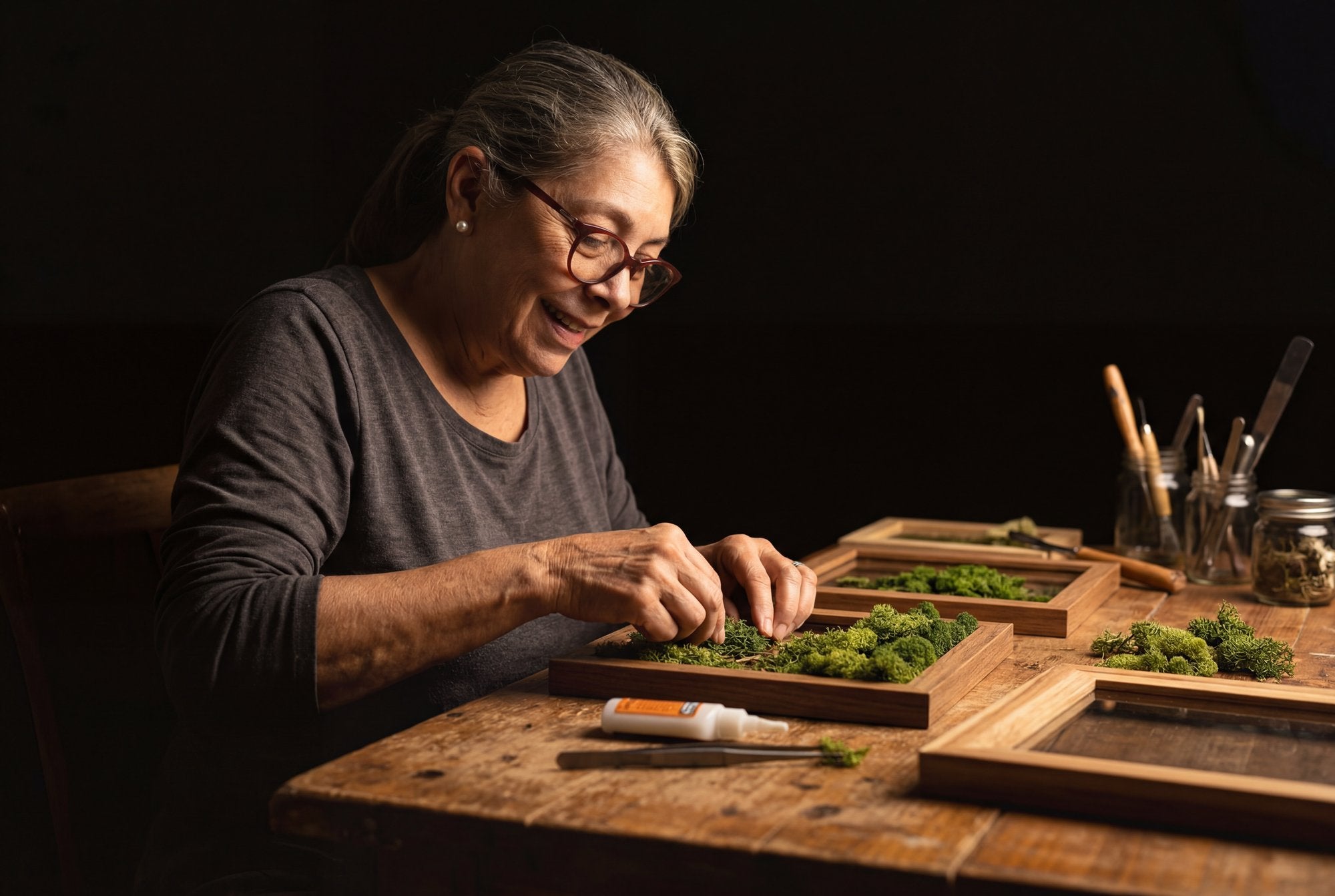 Maru crafting biophilic moss art in her studio